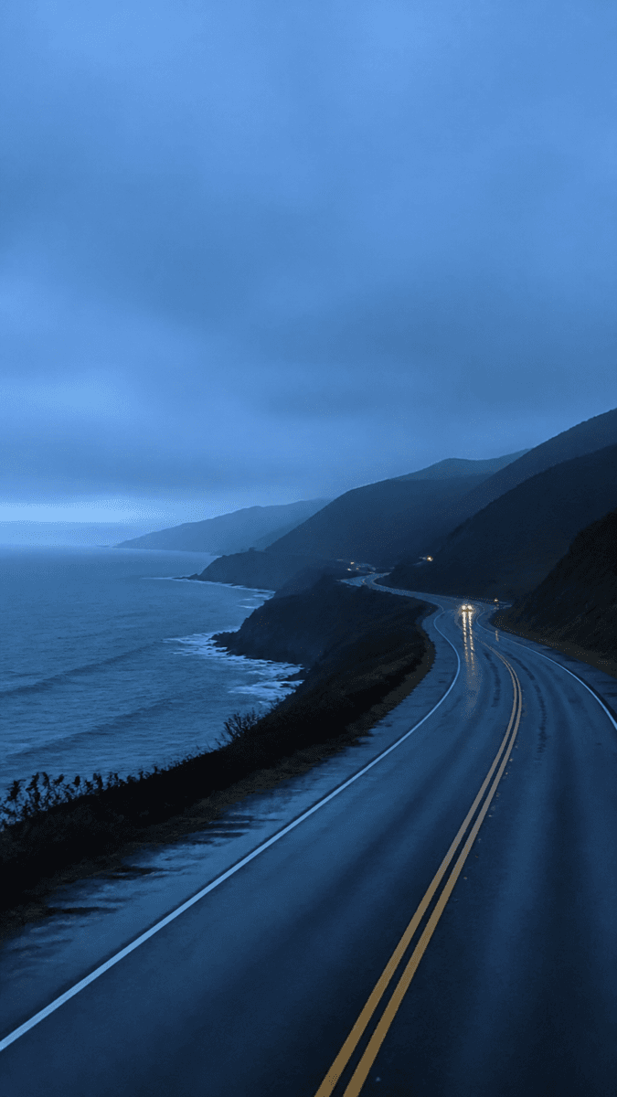 A coastal highway curving along the shore at dusk — natural capture