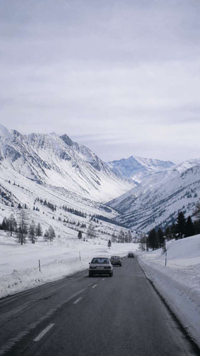 A snow-covered mountain valley under a flat sky — natural capture