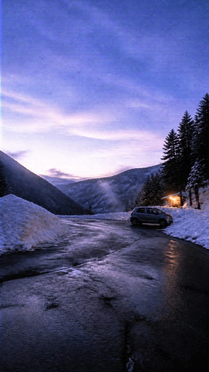 A snow-covered mountain valley under a flat sky — Y2K look